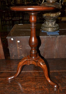 Lot 1405 - A mahogany kettle stand with circular moulded top raised on a baluster support with three...