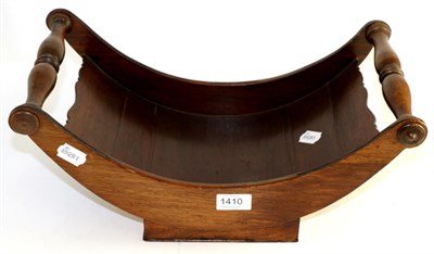 Lot 1410 - A Georgian mahogany cheese coaster with turned wood handles, on plain base, 53cm wide