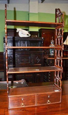 Lot 1418 - A set of four tier mahogany hanging shelves fitted with two drawers, 50cm wide