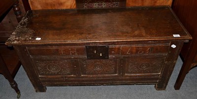 Lot 1422 - {} A 17th century joined oak chest with hinged lid, carved EM and dated 1681, 112cm wide