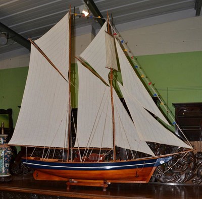 Lot 1431 - A 20th century scale model of a steam ship with linen sail and blue painted hull, maximum width...