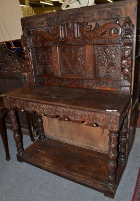 Lot 1434 - A carved oak table with panel back named Gilberd & Dorothy North, 120cm wide