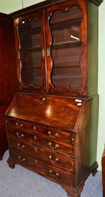 Lot 1442 - A George II mahogany bureau bookcase, 3rd quarter 18th century with a dentil cornice above...