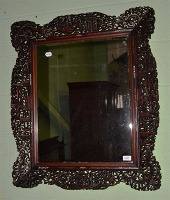 Lot 1447 - A Chinese bevel glass mirror in a frame decorated with figures in a landscape, 84cm high