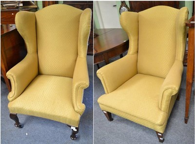 Lot 1455 - A late 19th century wing backed chair upholstered in gold fabric 77cm wide, and a similar chair...