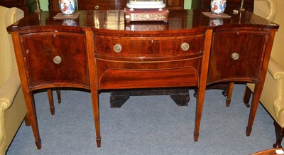 Lot 1456 - A George III mahogany and tulip wood banded serpentine shaped sideboard with brass gallery...