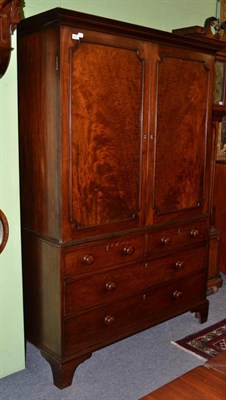 Lot 1473 - A George III mahogany linen press the interior with two sliding trays, the base with two short over