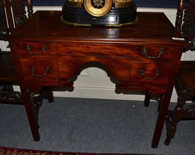 Lot 1477 - A George III mahogany lowboy with three drawers above an arched apron, 89cm wide