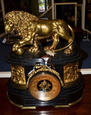 Lot 1478 - A black slate striking mantel clock, circa 1880, surmounted by a lion, side gilt metal panels...