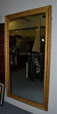 Lot 1521 - A 19th century gilt and gesso wall mirror with a rock work frame, 197cm high