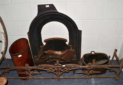 Lot 1526 - A cast iron fire curb, 150cm wide, cooking pot, a leather bound oval bin, fire basket and an insert