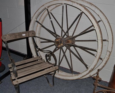 Lot 1527 - A pair of vintage cart wheels, diameter 116cm and a wrought iron armchair with a wooden slatted...