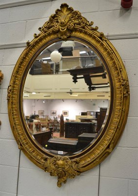 Lot 1532 - A Victorian style gilt oval mirror of recent date, height 150cm