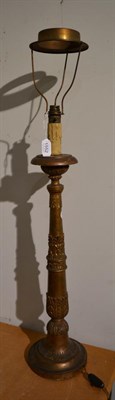 Lot 1552 - A 19th century gilt and carved wood candlestand, of slender baluster form with formal leaf...