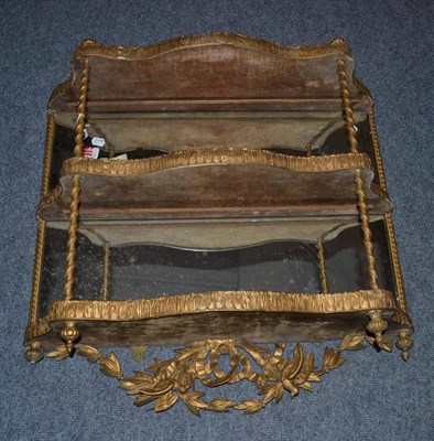 Lot 1553 - A 19th century gilt mirrored wall shelf, 82cm wide