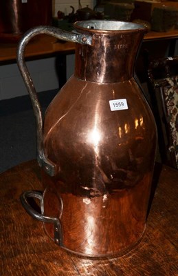 Lot 1559 - An early French 19th century copper flagon, 52cm high