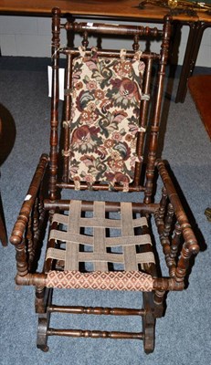 Lot 1560 - # A turned beach rocking chair, early 20th century, raised on castors, 55cm wide