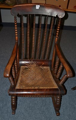 Lot 1562 - A fruitwood bobbin back rocking chair, 60cm wide