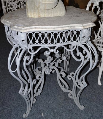 Lot 1565 - A grey marble top table with grey painted metal scrolled base, 66cm diameter