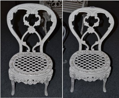 Lot 1568 - A pair of Victorian style white painted garden chairs, 83cm high