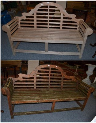 Lot 1569 - {} A teak hardwood bench in weathered condition, 193cm wide together with a matching untreated...