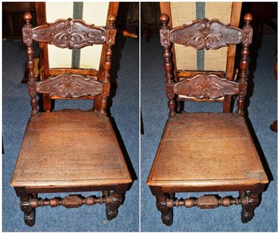 Lot 1575 - A pair of carved oak hall chairs, 48cm wide