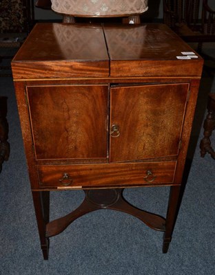 Lot 1580 - A George III mahogany washstand with hinged lid and a rise and fall mirror and two cupboard...