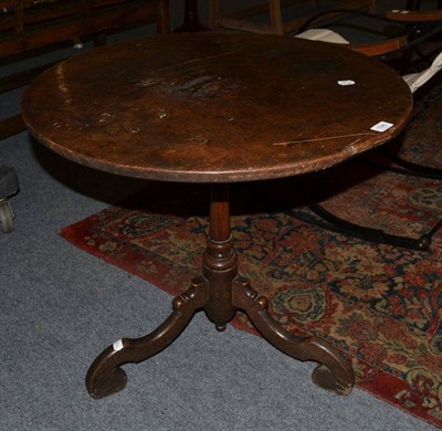 Lot 1596 - {} A George III oak tilt top tripod table, 70cm wide