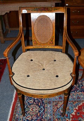 Lot 1606 - An Edwardian satinwood and polychrome painted armchair with caned seat and squab cushion, 50cm wide