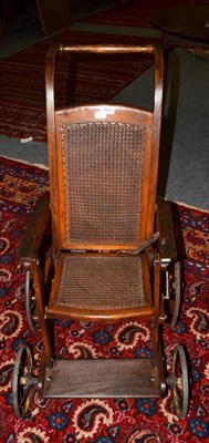 Lot 1608 - A child's caned invalids chair, 87cm high