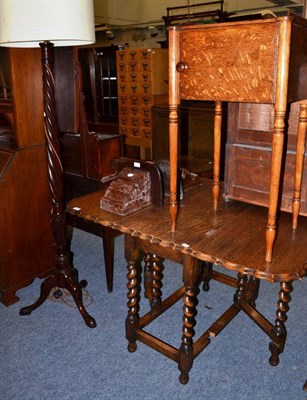 Lot 1613 - {} A 1920's oak gateleg table, a mahogany spiral turned standard lamp, a 19th century picture frame