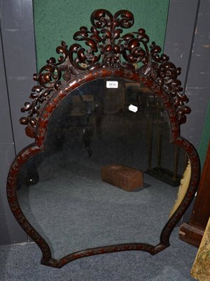 Lot 1614 - A late 19th/early 20th century carved mahogany wall mirror, shaped mirror plate in a leaf decorated