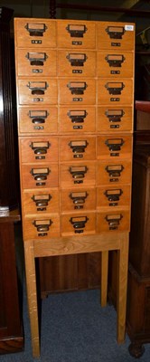 Lot 1623 - A set of oak index drawers of recent date on stand, 162cm high