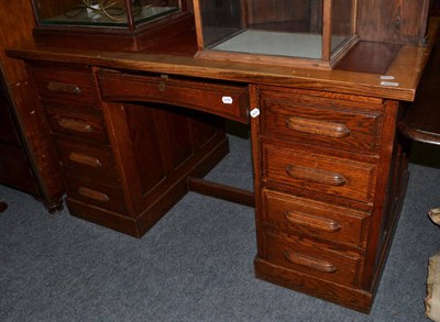 Lot 1633 - A 1920/30's oak double pedestal desk with red leather top, 140cm wide