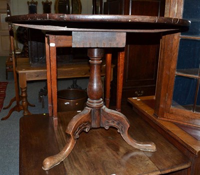 Lot 1634 - ^ A George III mahogany tripod table, with flip top above a bird cage platform, baluster...