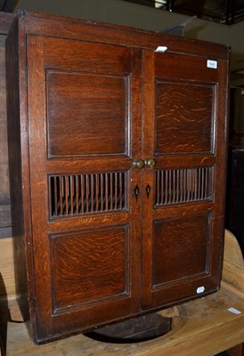 Lot 1645 - An oak food cupboard with grill doors, 65cm wide