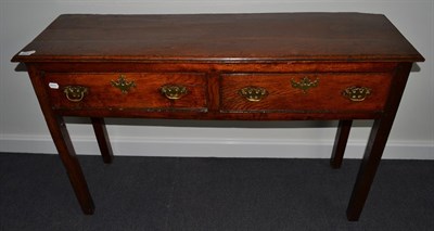 Lot 1679 - {} An 18th century two drawer table raised on block legs, 123cm wide