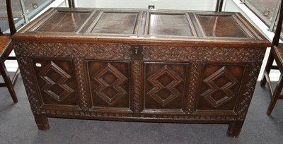 Lot 1683 - {} A 17th century joined oak chest with hinged lid above four geometric moulded panels, 141cm wide