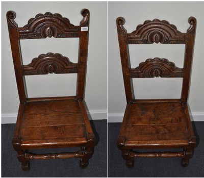 Lot 1686 - {} A pair of 17th century Yorkshire crescent top chairs with boarded seats, 45cm wide