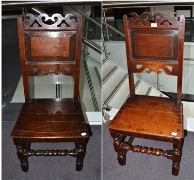 Lot 1690 - {} A pair of early 18th century joined oak chairs with fielded panel back supports and boarded...