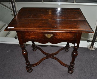 Lot 1691 - {} A William and Mary oak side table with single frieze drawer raised on baluster legs joined...