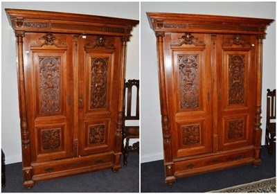 Lot 1696 - A pair of 19th century French walnut renaissance style armoires, with cupboard doors enclosing...