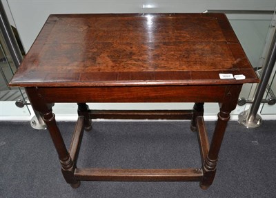 Lot 1697 - {} An 18th century oak and mahogany cross banded side table, raised on turned legs, 71cm wide