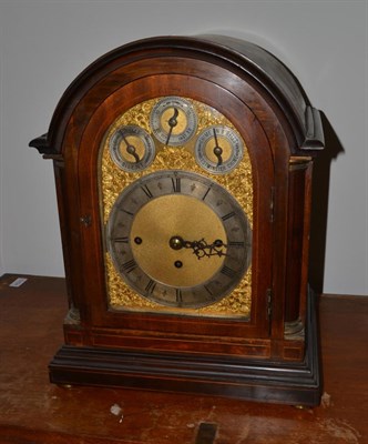 Lot 1703 - A mahogany chiming table clock, circa 1900, arched pediment, side frets, bun feet, 8-inch...