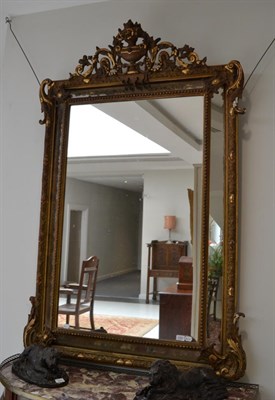 Lot 1707 - A 19th century gilt and gesso wall mirror with decorative urn shaped plume, 170cm high