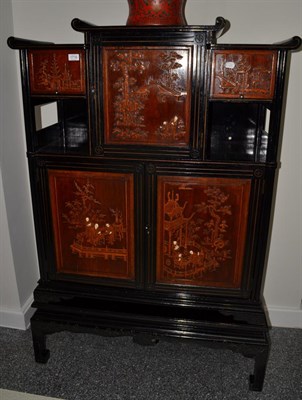 Lot 1716 - A Chinese ebonised softwood cabinet on stand, 199cm wide