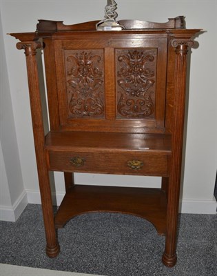 Lot 1720 - A Victorian carved oak writing cabinet, fall front carved with acanthus scrolls and a green man...