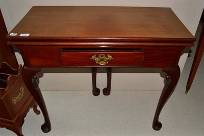 Lot 1745 - An 18th century mahogany card table raised on cabriole legs, 83cm wide