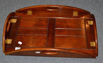 Lot 1772 - A mahogany butlers tray of oval form with four hinged borders, 69cm wide