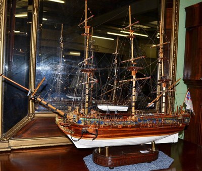 Lot 1778 - A model of an 18th century three masted galleon raised on a wooden plinth, maximum width 90cm